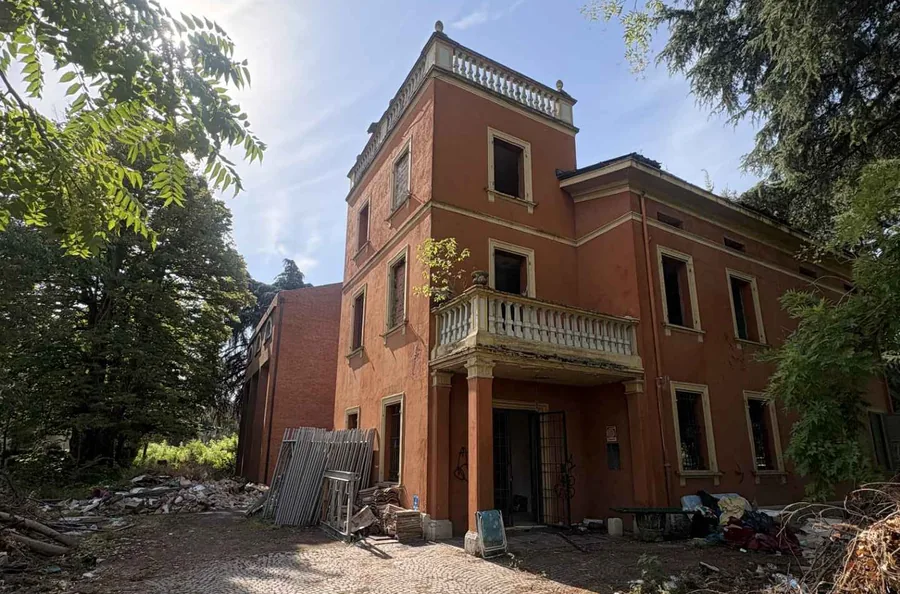 Villa A1 as found: the entrance tower with its balustraded roof terrace and first-floor balcony, the ground around it a building yard